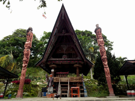 Pulau Samosir, Lake Toba, Sumatra, Indonesia, January 13, 2018: Traditional wooden house with two...