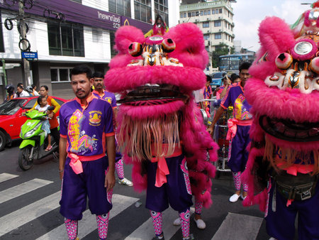 Bangkok, Thailand, November 14, 2015: A man with two dancing lions in a Festival of the Clans of the...