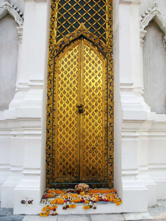 Bangkok, Thailand, January 11, 2016: Golden gate with offerings in one of the Mausoleums of the Thai royal family of the Royal Cemetery at Wat Ratchabophit temple in Bangkokのeditorial素材