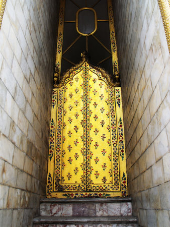 Bangkok, Thailand, January 25, 2013: A golden door in a building of the Royal Palace in Bangkok
