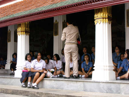 Bangkok, Thailand, January 25, 2013: A school teacher and his students during a class at the Royal Palace in Bangkokのeditorial素材