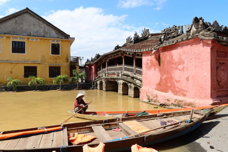 Hoi An, Vietnam, October 29, 2020: A woman in a boat next to the Japanese Bridge flooded due to the overflow of the Thu Bon River in the city of Hoi An due to the passage of Typhoon Molaveのeditorial素材