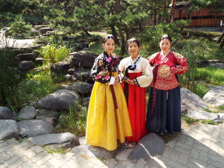 Seoul, South Korea, September 26, 2016: Three girls in hanbok, traditional Korean dress in the gardens of the Namsangol Hanok Village in Seoulのeditorial素材