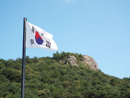 Bongha Village, Gimhae, South Korea, October 8, 2017: South Korean flag next to a mountain in Bongha Village, birthplace of Roh Moo-hyun, 16th President of South Koreaのeditorial素材
