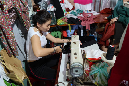 Hoi An, Vietnam, November 16, 2020: A woman works in a sewing shop in the Ba Le market in Hoi Anのeditorial素材