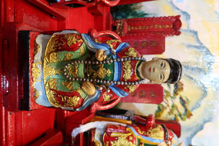 Hoi An, Vietnam, October 10, 2021: Colorful small sculpture of a deity on the altar of the prayer hall of the Hy Hoa temple in Hoi An, Vietnamのeditorial素材