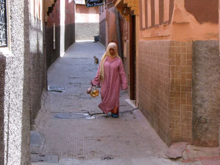 Marrakech, Morocco, August 13, 2012: A girl on a street in Marrakech. Moroccoのeditorial素材