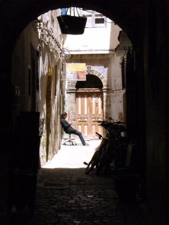Essaouira, Morocco, August 15, 2012: A woman sitting in an alley in the city of Essaouira, Moroccoのeditorial素材
