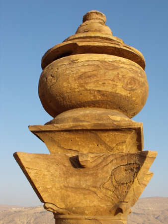Petra, Jordan. August 16, 2010: Detail of the vertical view of the upper adornment of the facade of the Monastery with the mountain in the background in Petra, Jordanのeditorial素材