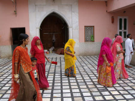 Karni Mata Rat Temple, Deshnok, Bikaner, Rajasthan, India, August 12, 2011: Group of women in colorful clothing at the Karni Mata Rat Temple in Deshnok, Indiaのeditorial素材