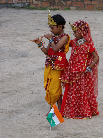 Rajasthan, India, August 15, 2011: Boy and girl dressed in colorful clothes dancing in a school in the celebration of India's independence dayのeditorial素材