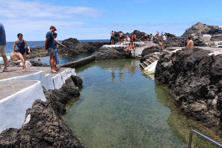 Garachico, Tenerife, Canary Islands, Spain, July 6, 2022: Tourists enjoying the sun and water in the El Caleton natural pools, Garachico, Tenerife. Spainのeditorial素材