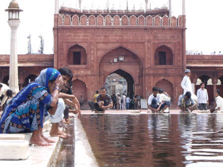 Jama Masjid Mosque, New Delhi, India, August 9, 2011: Many worshipers perform their ablutions in the designated area next to the main entrance of the Jama Masjid Mosque in New Delhi, Indiaのeditorial素材
