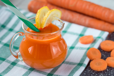 Carrot juice in glass and fresh carrots. Healthy food.の写真素材