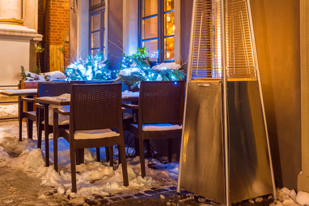 Street cafe with fireplace by night in Gdansk in winter time. Poland, Europe.の写真素材