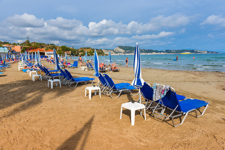 ZAKYNTHOS, GREECE - September 28, 2017: Parasols and sunbeds on Argassi beach, one of the best beautiful sandy beaches of east coast of Zakynthos island.  Ionians Islands, Greece.のeditorial素材