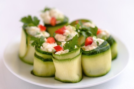 Rolls of zucchini stuffed with cheese and chives and red paprika.の写真素材