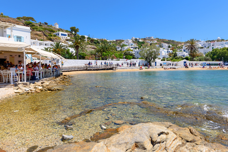MYKONOS, GREECE, MAY 23, 2017: Sea bay and coastal promenade with restaurant in beautiful town of Mykonos. Cyclades islands, Greece.のeditorial素材