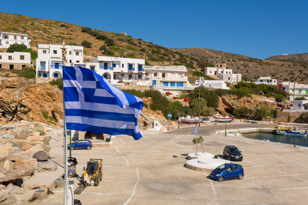 SIKINOS, GREECE - May 20, 2017: Greek flag and port of Sikinos island. Cyclades, Greeceのeditorial素材