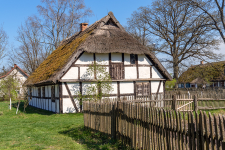 Wooden fence and old house in museum of the Kluki village in Slowinski National Park. Polandのeditorial素材