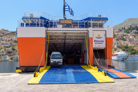 SYMI, GREECE - May 15, 2018: Panagia Skiadeni ferry unloading at the port of Gialos during the...