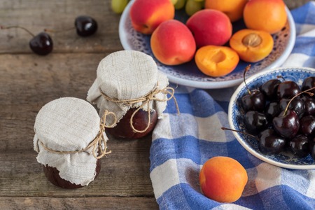 Homemade jam with fresh fruits over on wooden table. Rustic style.の写真素材