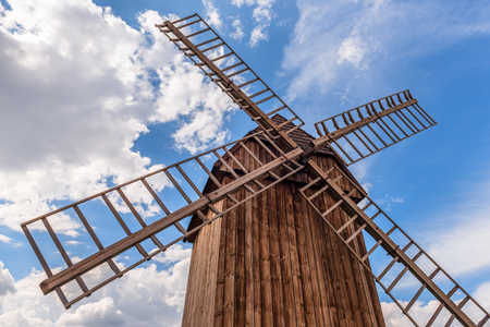 Traditional wooden windmill under blue sky. Poland.の写真素材