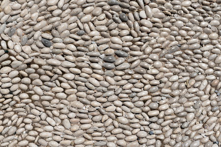 Texture and background with small pebbles. Sidewalk on a street in Rhodes. Greeceの写真素材