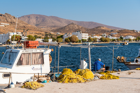 SERIFOS, GREECE - September 9, 2018: Morning in the port of Livadi. Fisherman sorting out the catch on a fishing boat. Serifos island, Greeceのeditorial素材