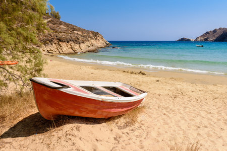 Boat on Psilli Ammos beach with soft powder sand and a shallow turquoise bay. Serifos island, Cyclades, Greeceの写真素材