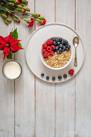 Breakfast, oatmeal with blueberry and raspberry on white bowl. Healthy foodの写真素材