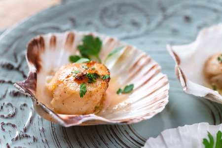 Seared scallops shell with butter, garlic and parsley.