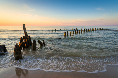Stakes on the Baltic sea at sunset time, Karwia village, Polandの写真素材