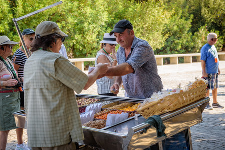 ATHENS, GREECE - September 14, 2018: A man selling local delicacies in the city center of Athens.のeditorial素材