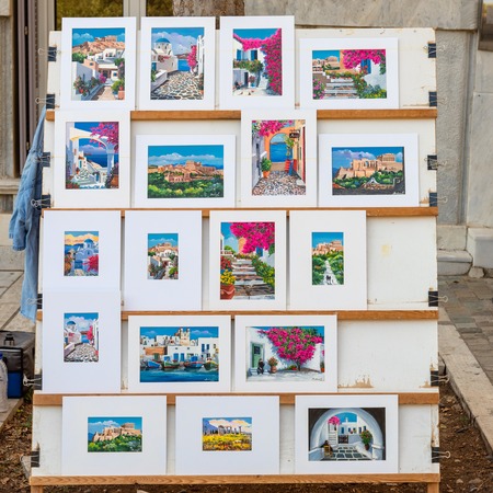 ATHENS, GREECE - September 14, 2018: Hand-painted paintings with Greek landscapes sold on the street of Athens.のeditorial素材