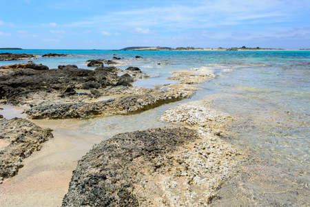 Rocky coast of Elafonisi beach with crystal clear water in summer day. Crete Island, Greeceの写真素材