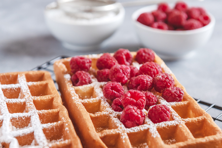 Homemade waffles with raspberries and powdered sugarの写真素材