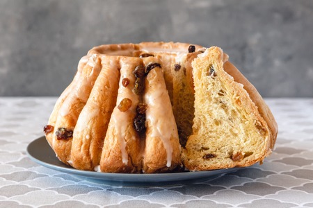 Traditional yeast ring cake with icing and raisins.の写真素材