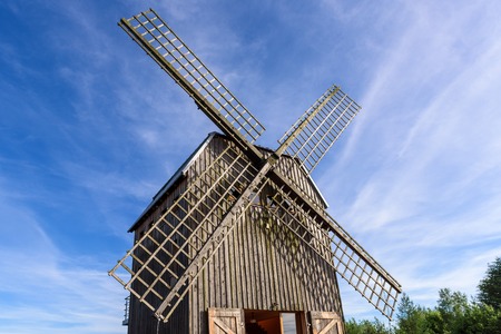 REBOSZEWO, POLAND - June 2, 2019: A wooden windmill located in the village of Reboszewo at the Brodno Lake. It offers a garden, bar and terrace with a lake-view.のeditorial素材