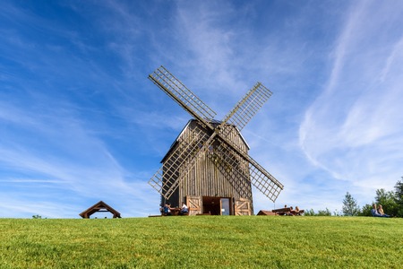 REBOSZEWO, POLAND - June 2, 2019: A wooden windmill located in the village of Reboszewo at the Brodno Lake. It offers a garden, bar and terrace with a lake-view.のeditorial素材