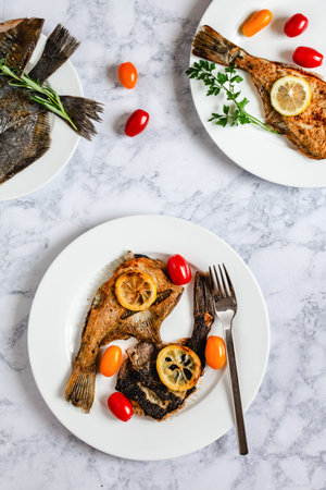 Grilled flounder fish served on white plate