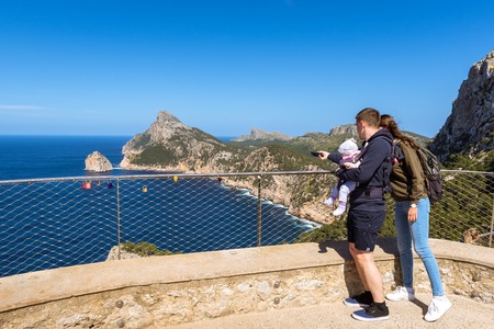 MALLORCA, SPAIN - May 6, 2019: A couple with a child taking pictures of beautiful rocks at Cap de Formentorのeditorial素材