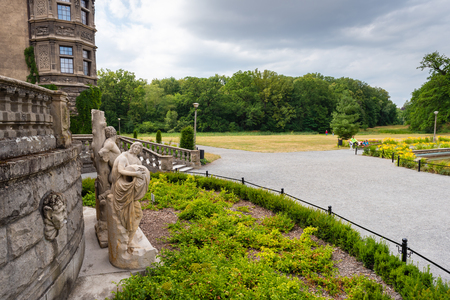 MOSZNA, POLAND - July 16, 2019: Green area of the Moszna Castle in southwestern Poland, one of the most magnificent castles in the world from 17th century.のeditorial素材