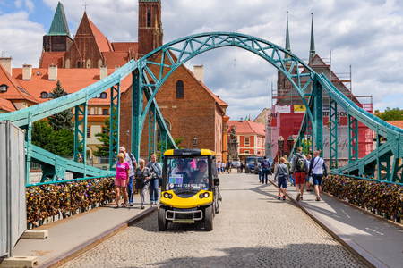 WROCLAW, POLAND - July 17, 2019: Mini bus and tourists on the Tumski Bridge in Wroclaw on a summer day.のeditorial素材