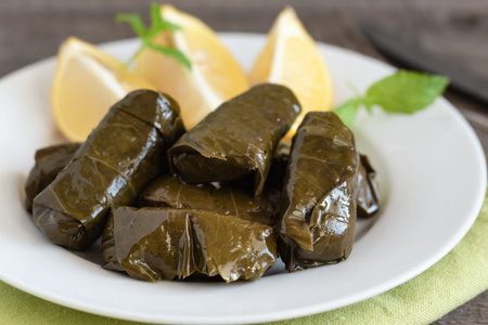 Grape leaf filled with rice served with lemon. Traditional Greek food
