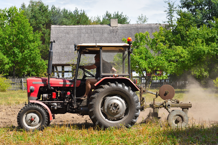 Osiek, Poland - August 16, 2019: Tractor in the field. Open-air museum in Osiek by the river Notec.のeditorial素材