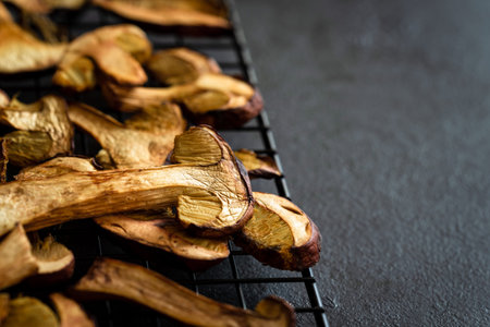 Drying fresh forest mushrooms on wooden table.