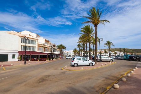 Menorca, Spain - October 12, 2019: Street with palm trees in beautiful Fornells village in the north of Menorcaのeditorial素材