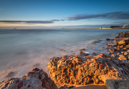 Rocky beach of the Baltic Sea at sunset light. Poland.