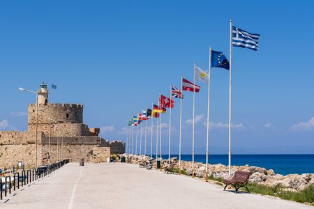 Seaside promenade and the fort of St. Nicholas in Mandraki port of Rhodes. Greeceの写真素材